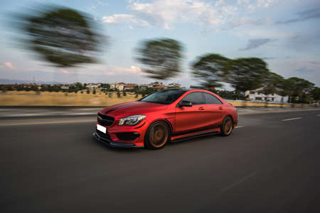 Red sport car high speed drive on the roadの写真素材