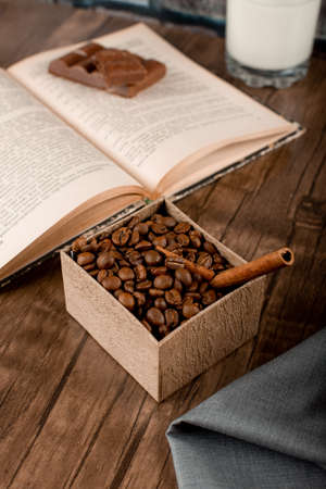 Coffee beans in a cardboard box and a bookの写真素材