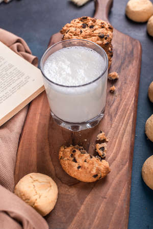 A glass of milk with sweet cookiesの写真素材