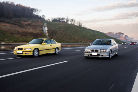 Yellow and silver sport cars race