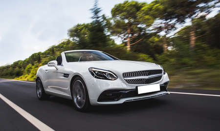 White cabriolet commercial in the nature