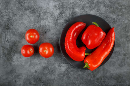 Red chilies and tomatoes on the blue background. Top view.の写真素材