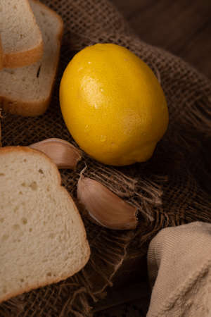 Fresh yellow lemon with garlicsの写真素材