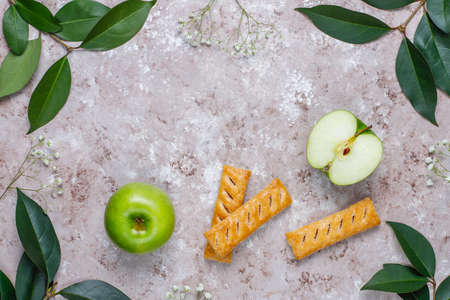 Apple puff pastry cookies in apple shape plate with fresh apples ,top viewの写真素材