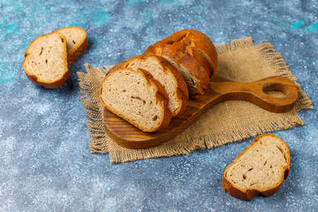 Sliced wholegrain bread on cutting board,top view