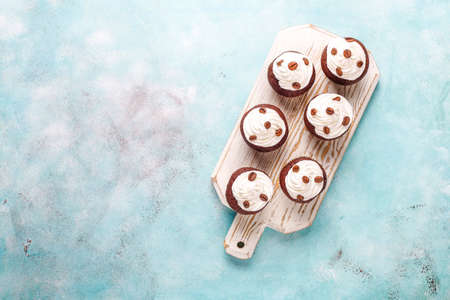 Coffee cupcakes decorated with whipped cream and coffee beans.の写真素材