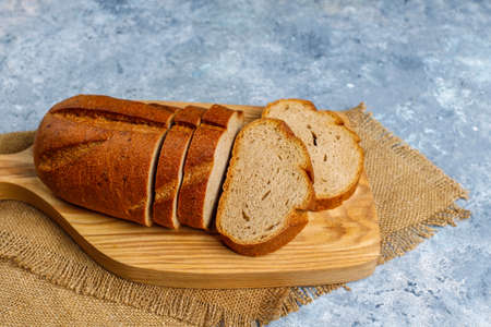 Sliced wholegrain bread on cutting board,top view