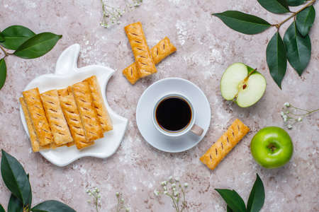 Apple puff pastry cookies in apple shape plate with fresh apples ,top viewの写真素材