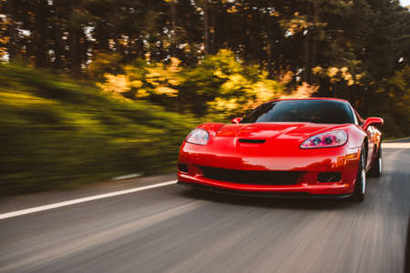 Red sport sedan on the highwayの写真素材
