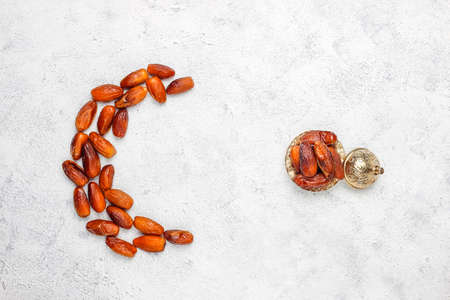 Beautiful bowl full of date fruits symbolizing Ramadan,top viewの写真素材