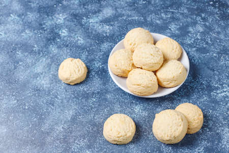 Various cookies in a wooden tray on gray background