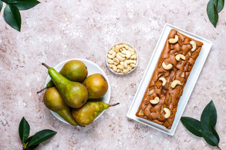 Homemade rustic chocolate cake with pear and cashew nuts,top viewの写真素材