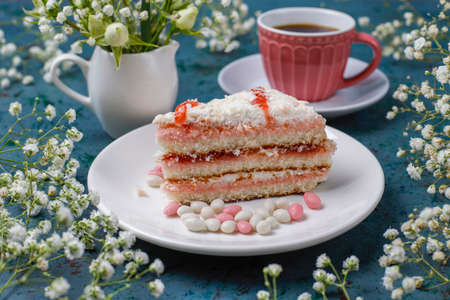 Victoria sponge cake slices with a cup of coffee on light background,top view