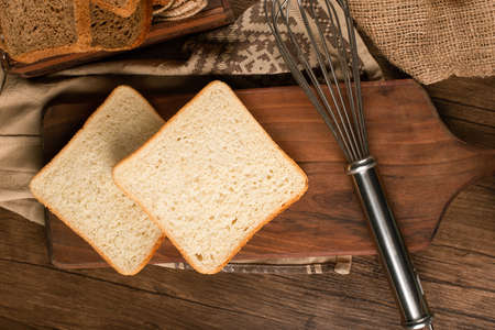 Slices of white bread on kitchen board