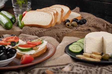 Sandwiches with white cheese and vegetables.