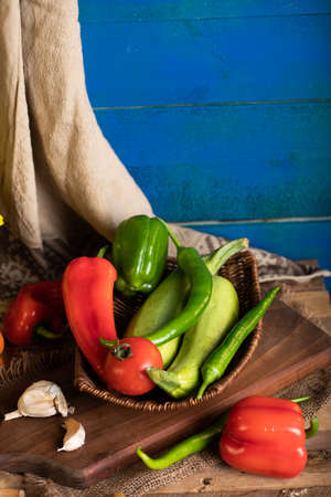 Zucchini, tomato, pepper and garlics on the wooden boardの写真素材