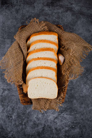 Bread slices on a burlap on a blue background.