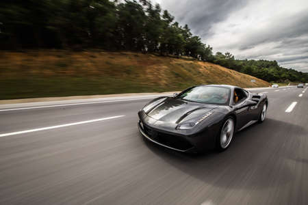 Silver sport model cabriolet on the highwayの写真素材