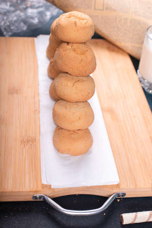Butter cookies pile on a wooden boardの写真素材