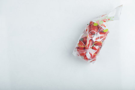 Organic Cherry tomatoes in a plastic packageの写真素材