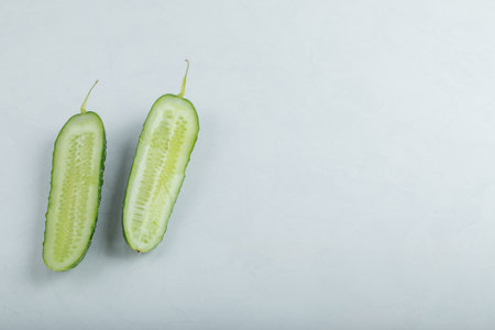 Close-up of fresh green slices of cucumber isolated on white background.の写真素材