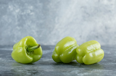 Organic fresh green pepper on grey backgroundの写真素材