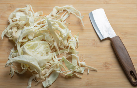 Close up photo of chopped cabbage in wooden background