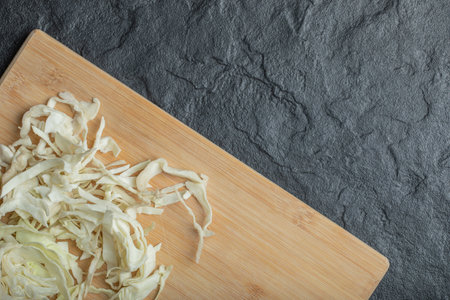Chopped white cabbage on the wooden cutting boardの写真素材