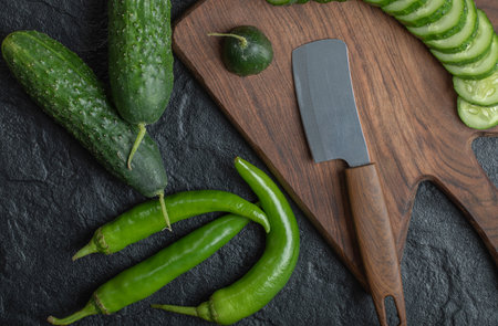 Close up photo of Sliced cucumber and hot green peppers
