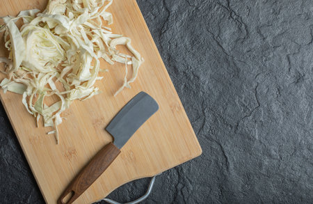 close up Photo of chopped cabbage and knife on the wooden cutting boardの写真素材