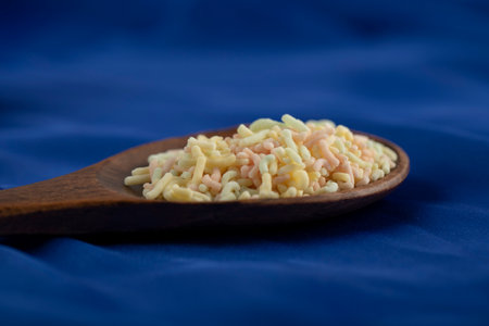 A wooden spoon full of colorful sprinklesの写真素材