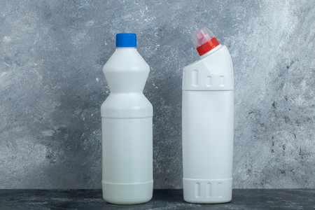 Chemical cleaning supply and bleach on marble background