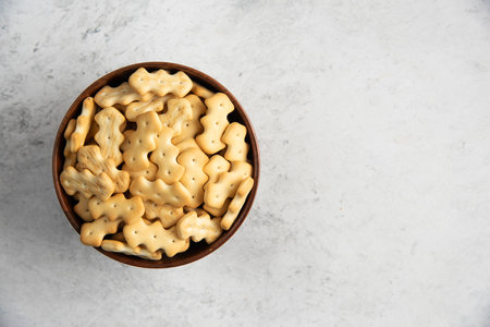 A wooden bowl full of delicious crackers