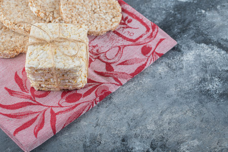 two types of tasty crispbread on red cloth