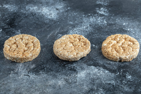 Three round crispbread on marble background