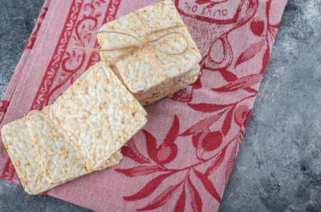 Stack of tasty crispbread on red cloth