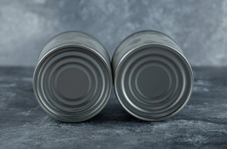 Two tin cans placed on marble backgroundの写真素材