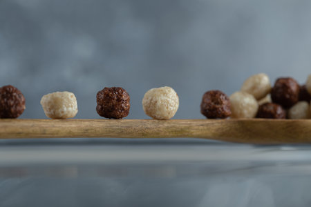 Spoon of cereal balls on marble background