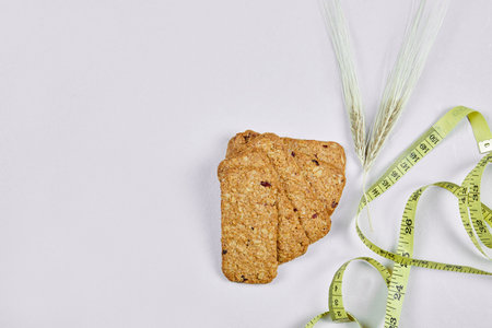 Biscuits and tape measure on a white backgroundの写真素材