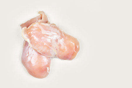 Raw chicken legs and fillet isolated on white backgroundの写真素材