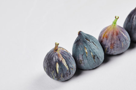 A bunch of ripe figs on a white backgroundの写真素材