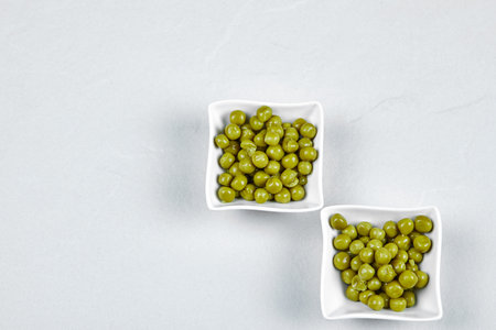 Marinated pea beans in white saucersの写真素材