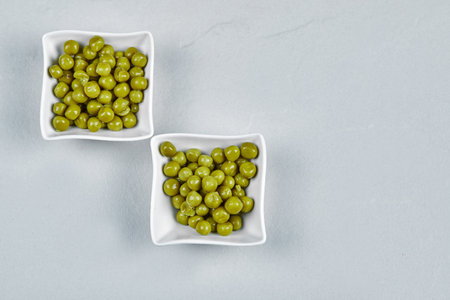 Marinated green pea beans in ceramic cupsの写真素材