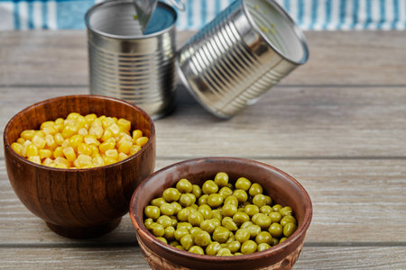 Marinated green pea beans and corns in wooden cupsの写真素材