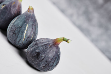 A bunch of ripe figs on a white backgroundの写真素材