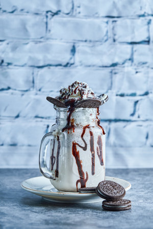 Oreo milkshake with sprinkling on the ceramic plateの写真素材