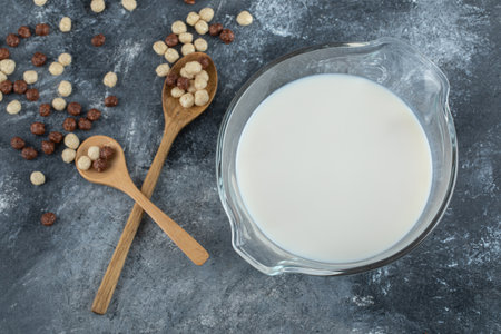 Bowl of milk and cereal balls on marble backgroundの写真素材