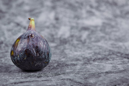 Ripe purple fig on a marble backgroundの写真素材