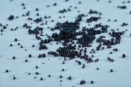 Black caviar scattered on the blue tableの写真素材