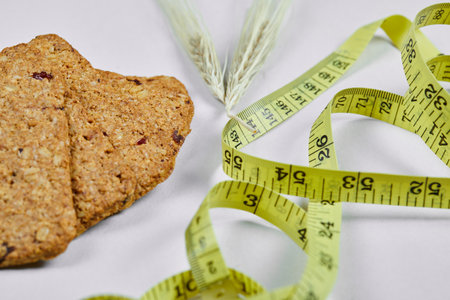 Biscuits and tape measure on a white background, close upの写真素材